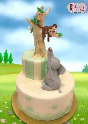 Tarta animales elefante bebé de dos pisos con elefante gris, mono en árbol y detalles verdes