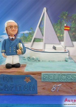 Tarta capitán de barco personalizada Madrid con vela blanca barco azul decoración marina vibrante