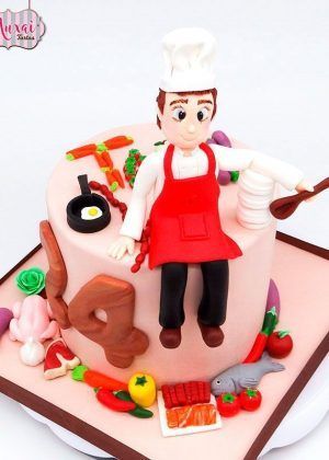 Tarta Cocinero - chef con figura modelada en fondant blanco y base chocolate oscura con detalles culinarios