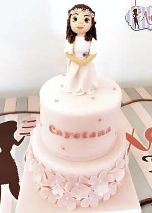 Tarta comunión flores sencillas rosa con figura 3D de niña y nombre Cayetana en Auxaitartas